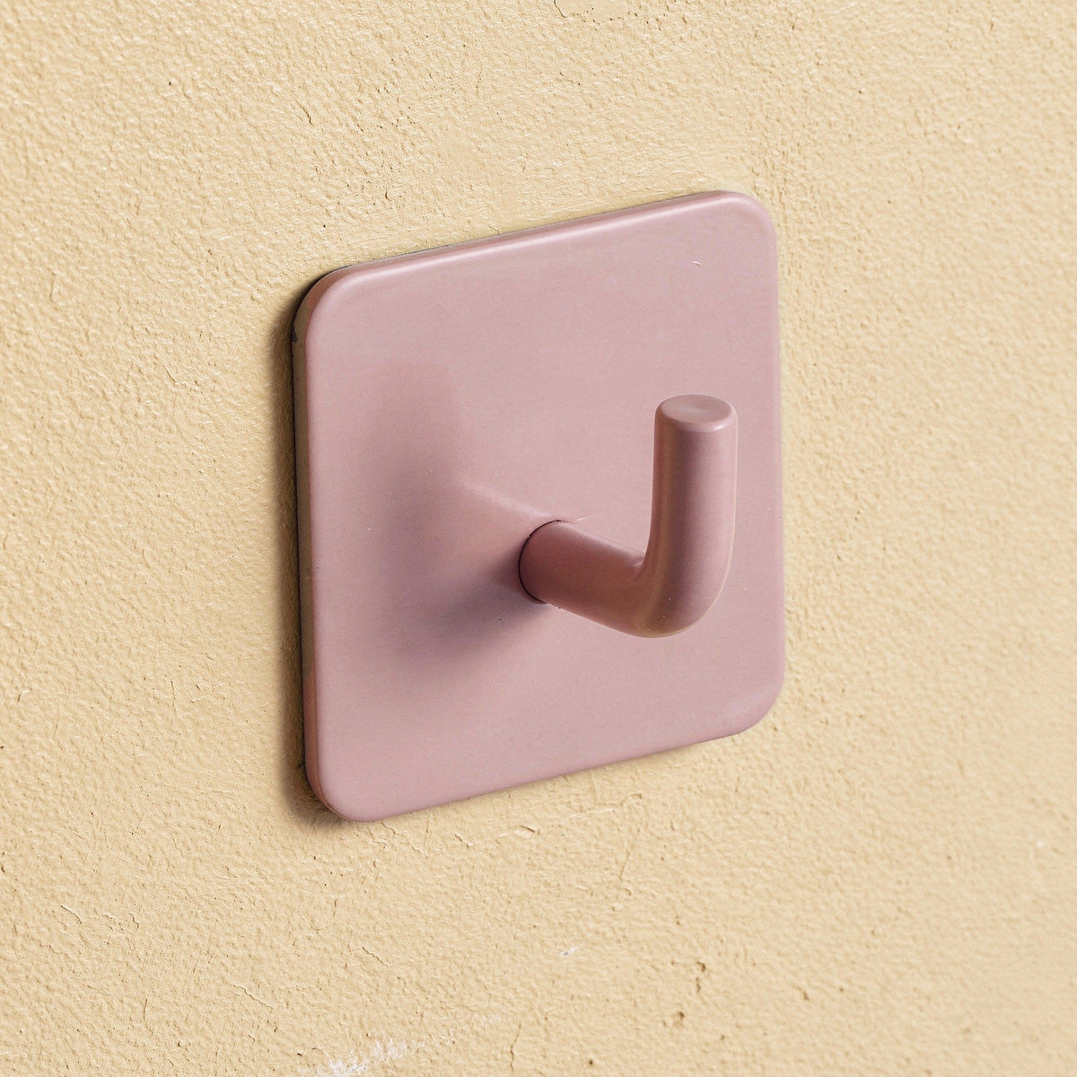 Klebehaken eckig in Rosa an der Wand